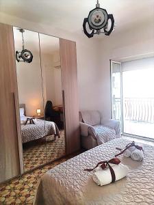 a bedroom with a mirror and a bed and a couch at Casa al centro in Palermo