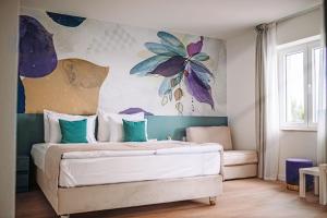 a bedroom with a bed with a painting on the wall at Villa Ardura - island holiday residence **** Bol. Island Brač in Bol