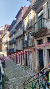 a group of buildings with colorful flags on a street at APOSENTUS - St Francisco Apartment in Porto