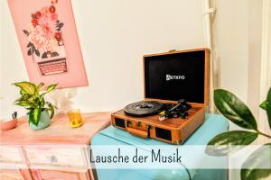 a tv sitting on top of a table at Uhlpartment - Romantisches Apartment im Zentrum in Uelzen +27 photos