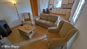 a living room with a couch and chairs and a table at Turismo Rural- Casas de Campo - Eco & Nature - Monte Horizonte in Santiago do Cacém