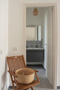 uma casa de banho com uma cadeira e um lavatório em Teia Holiday Apartments em Vulcano