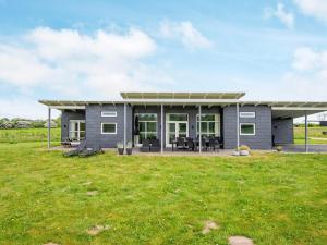 a modular home with a patio and grass at Holiday home Haderslev L in Haderslev