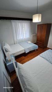 a bedroom with two beds and a chandelier at Madeline house in Kavala