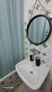 a bathroom with a sink and a mirror at Madeline house in Kavála