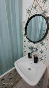 a bathroom with a sink and a mirror at Madeline house in Kavala