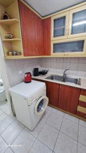 a kitchen with a washing machine and a sink at Madeline house in Kavála