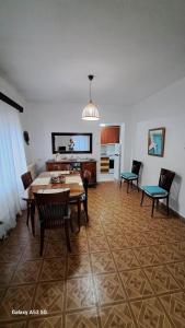a living room with a table and chairs and a kitchen at Madeline house in Kavala