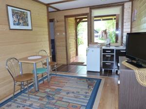a kitchen and dining room with a table and chairs at U Kaczorka in Ruciane-Nida