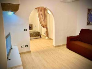 a living room with a couch and a bed at Lovely and cozy central apartment in the best position in Florence