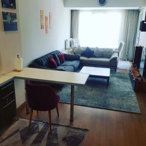 a living room with a table and a couch at Spacious One Bedroom Apartment in Esenyurt