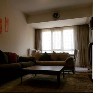 a living room with a couch and a coffee table at Spacious One Bedroom Apartment in Esenyurt