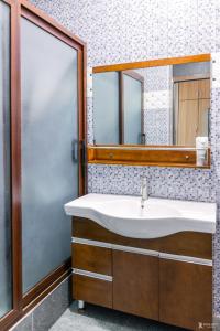 a bathroom with a sink and a mirror at Richjoy Lodge in Tema