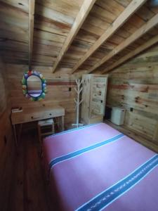 Postel nebo postele na pokoji v ubytování Cabaña Los Nogales
