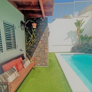 a living room with a couch and a swimming pool at Mara's House in Nazaret