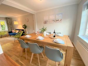 a large wooden table with chairs in a living room at Redhill Town Centre 3 bed House near Gatwick Airport, easy commute to London in Redhill