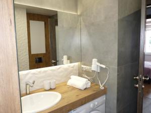 a bathroom with a sink and a mirror at Apartament nad jeziorem Sport i Rekreacja in Ełk