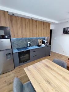 a kitchen with a table and a counter top at Apartament nad jeziorem Sport i Rekreacja in Ełk