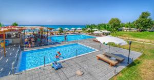 duży basen z ludźmi stojącymi wokół niego w obiekcie Ocean Hotel Resort w mieście Kastrosikia