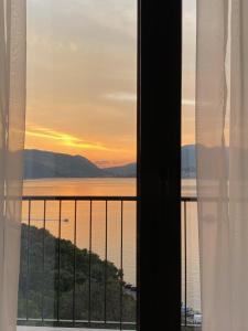 a view of the ocean from a hotel room window at Agape Rose Hotel in Tivat