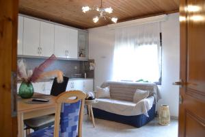 a living room with a couch and a table at Lazatka flat in capital Chora in Samothráki