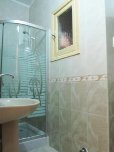 a bathroom with a glass shower and a sink at Arabian Nights Hostel in Cairo +63 photos