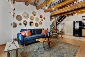 a living room with a blue couch and a table at Roua Ludica Apartments in Braşov