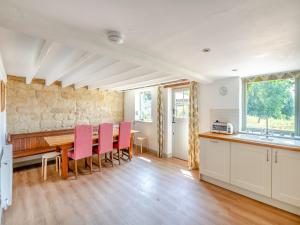 a kitchen and dining room with a table and chairs at Kingfisher Barn - Uk44098 in Carsington