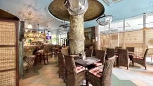 a restaurant with tables and chairs and a bar at Bratanov Yassen Holiday Vilage in Sunny Beach