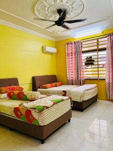 a room with three beds and a ceiling at MH Homestay No2 at Alor Setar in Alor Setar