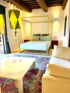 a bedroom with a bed and a table and a couch at Casa Fossatello in Nocera Umbra
