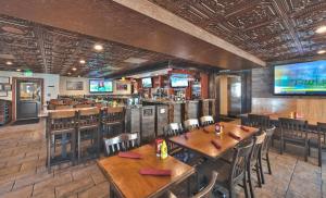 a restaurant with wooden tables and chairs and a bar at Ski in/out at Westgate, Remodeled Studio, Resort amenities, Multiple Pools, Spa and Restaurant 4503B in Park City
