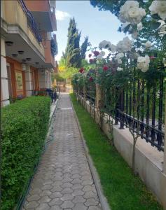 a walkway with flowers on the side of a building at Апарт-хотел ПОМОРИЕ РЕЗИДЕНС in Pomorie