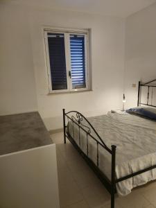 a bedroom with a bed and a window at Casa Vacanza Villa Andrea in Manduria