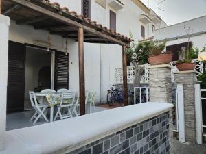 a patio with a table and chairs on a building at Casa Vacanza Villa Andrea in Manduria