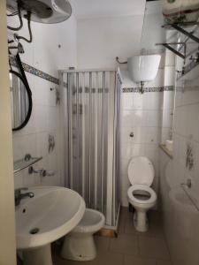 a bathroom with a sink and a toilet and a shower at Casa Vacanza Villa Andrea in Manduria