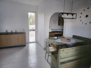 a kitchen with a table and a dining room at Casa Vacanza Villa Andrea in Manduria
