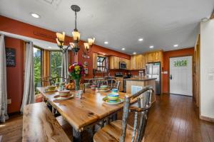a kitchen and dining room with a wooden table and chairs at Twinflower Summit - Incredible views, pet friendly! in Gatlinburg