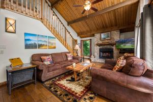 a living room with leather furniture and a fireplace at Twinflower Summit - Incredible views, pet friendly! in Gatlinburg