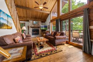 a living room with leather furniture and a fireplace at Twinflower Summit - Incredible views, pet friendly! in Gatlinburg