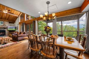 a dining room and living room with a table and chairs at Twinflower Summit - Incredible views, pet friendly! in Gatlinburg
