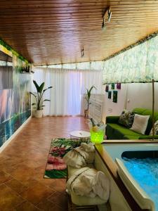 a living room with a couch and a swimming pool at Suite i biddizzi da Sicilia in Catania
