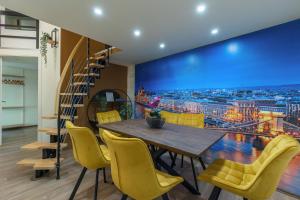 uma sala de jantar com uma mesa e cadeiras amarelas em Kazinczy 10 Apartment with 3 bedrooms em Budapeste