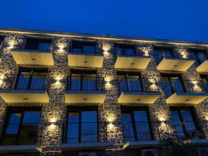 a facade of a building with lights on it at Agape Rose Hotel in Tivat