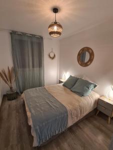 a bedroom with a large bed and a chandelier at Chambre d'hôtes Corse Villa Moorea chez l'habitant in Ventiseri