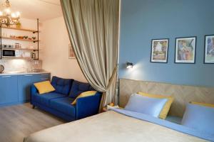 a bedroom with a blue couch and a blue sofa at Design Studio in Atlantis Resort&SPA, Burgas Airport in Burgas City