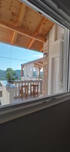 a large window with a view of a balcony at Holiday Home Peran in Grebaštica