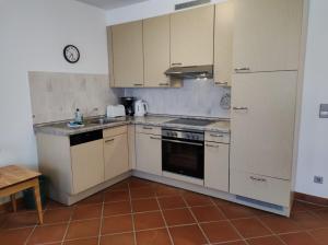 a kitchen with white cabinets and a stove top oven at Apartment Naturgenuss in Dewichow