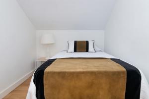 a bedroom with a large bed with a brown blanket at BHost - Historic Center Pastor in Málaga