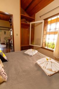 a bedroom with two beds and a window at Pousada Estrela da Serra in Monte Verde +200 photos